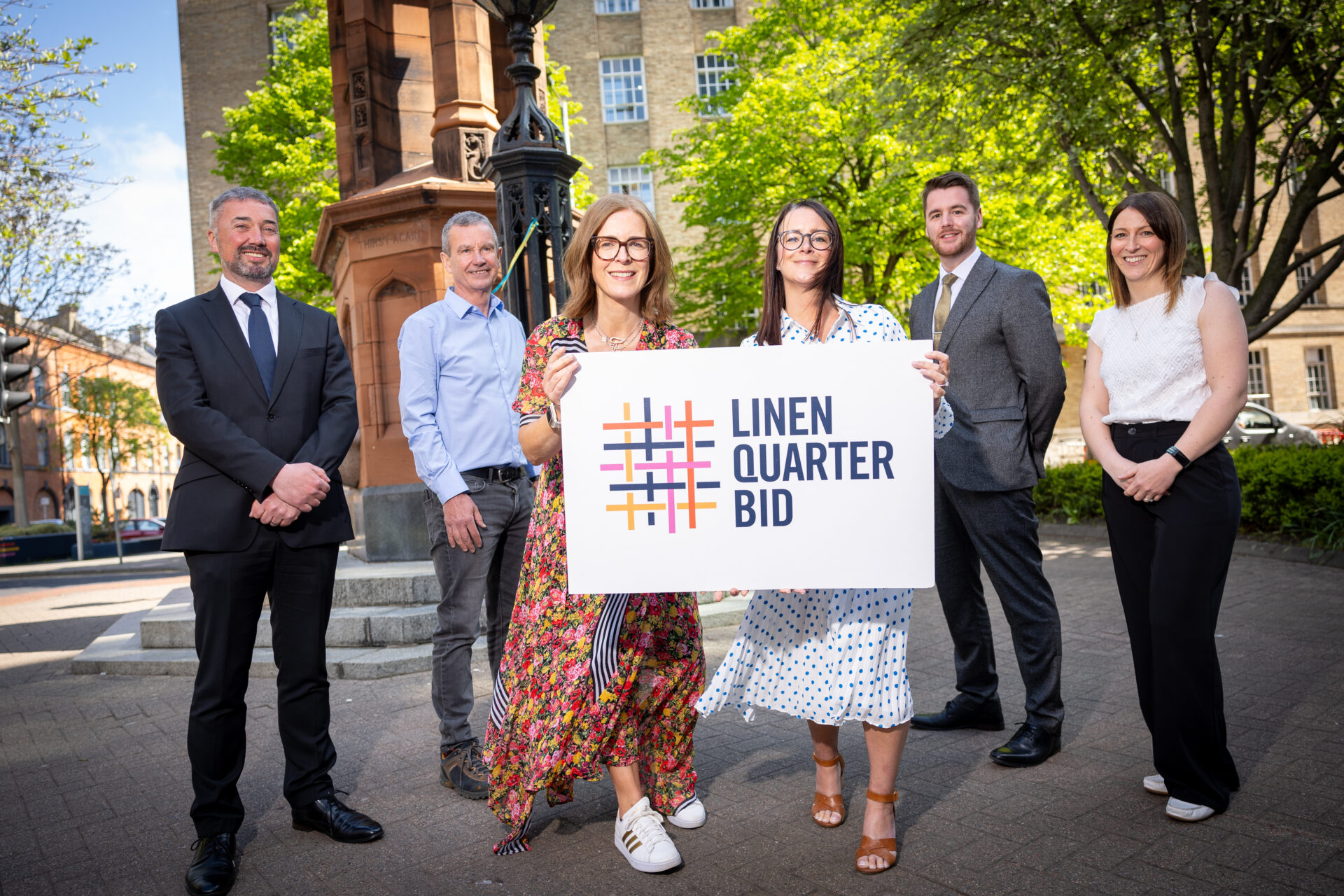Image shows the following people standing in front of an Edwardian Fountain, with trees in full bloom also in the background: L R Chris McCracken, Paul Roberts, Avril Keys, Jeanette Donohoe, Ruairi McLaughlin, Sarah Cull