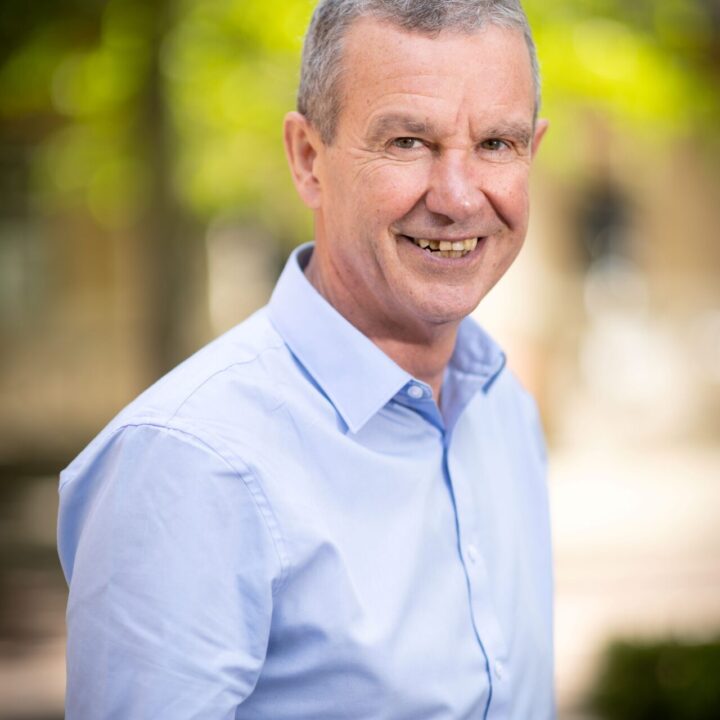 Paul Roberts in a blue shirt smiling