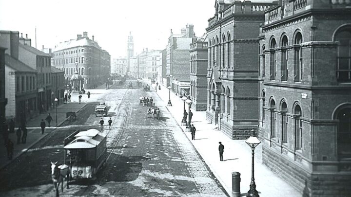 Horse tram 29 in Victoria Street passing the Petty Sessions Court, which until the City Hall was opened in 1906 served as the official Town Hall. On the left is Victoria Square and the Jaffe fountain, which was moved to Botanic Gardens in the 1930s but returned to its present location in 2008. [Credit: National Library of Ireland]